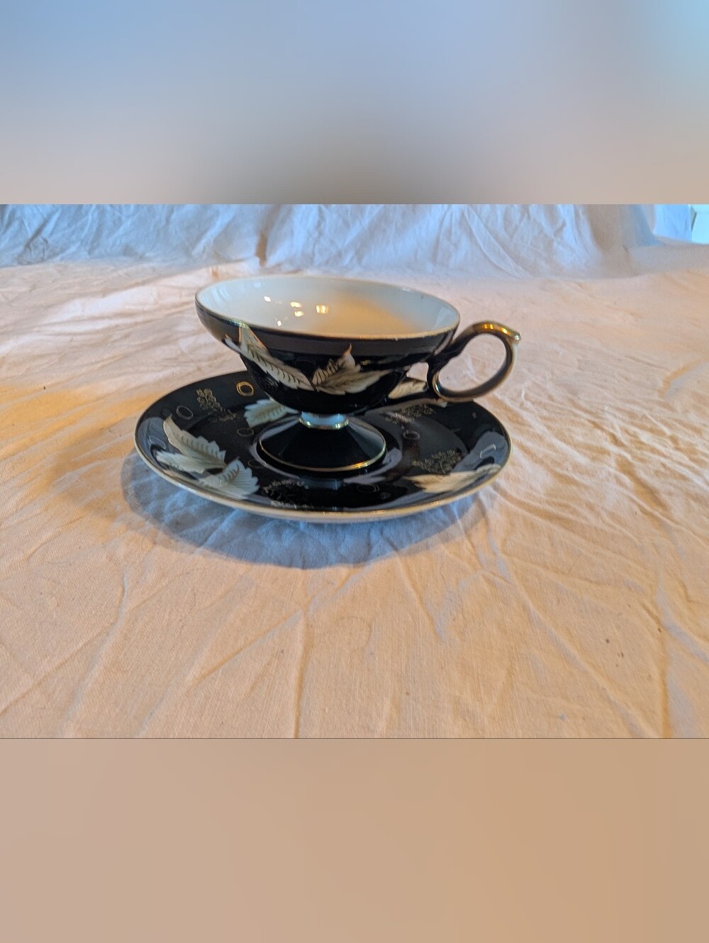 2/40$ Black and Cream Footed Teacup & Saucer with Gold Trim